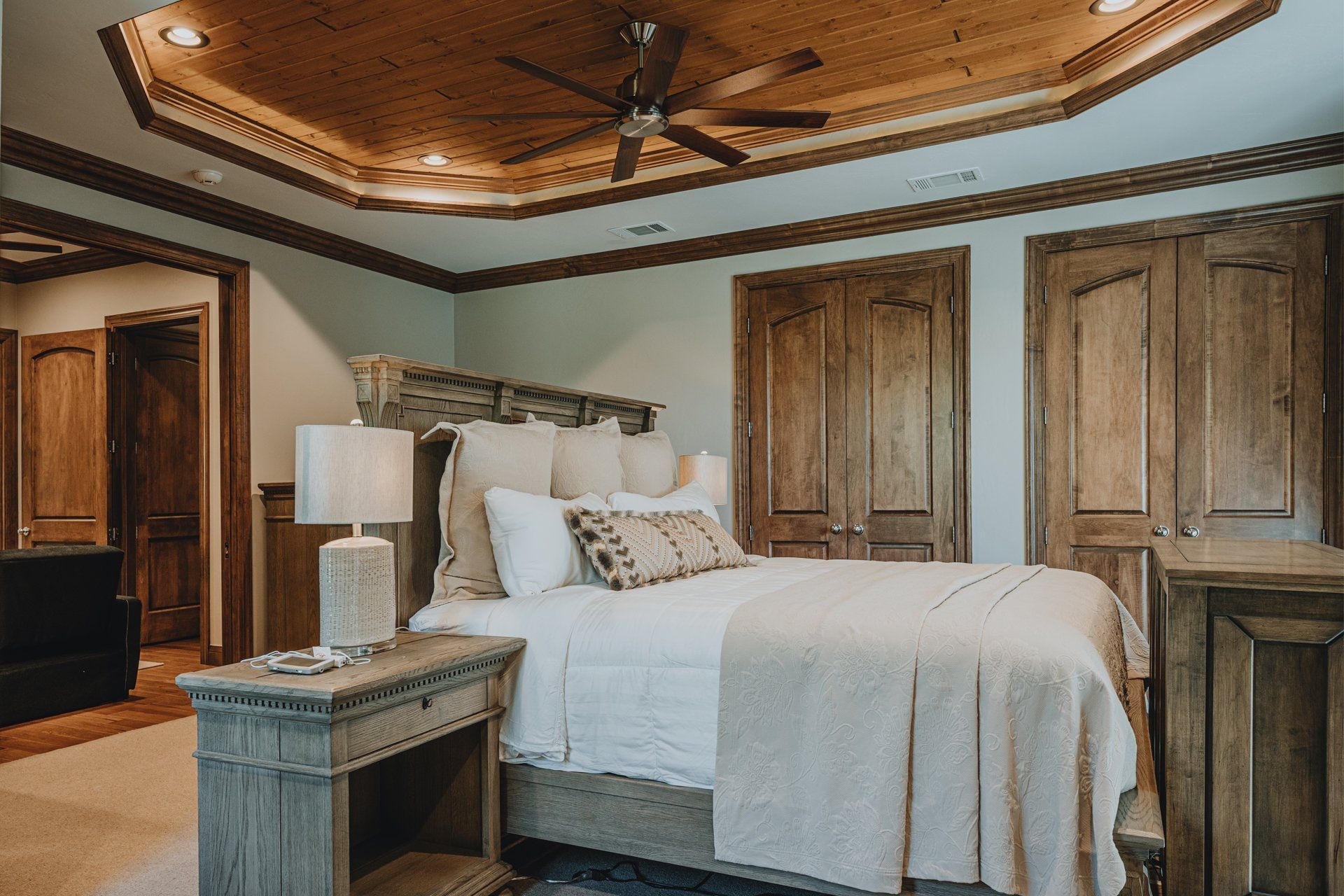 A bedroom with a bed , nightstand , and ceiling fan.