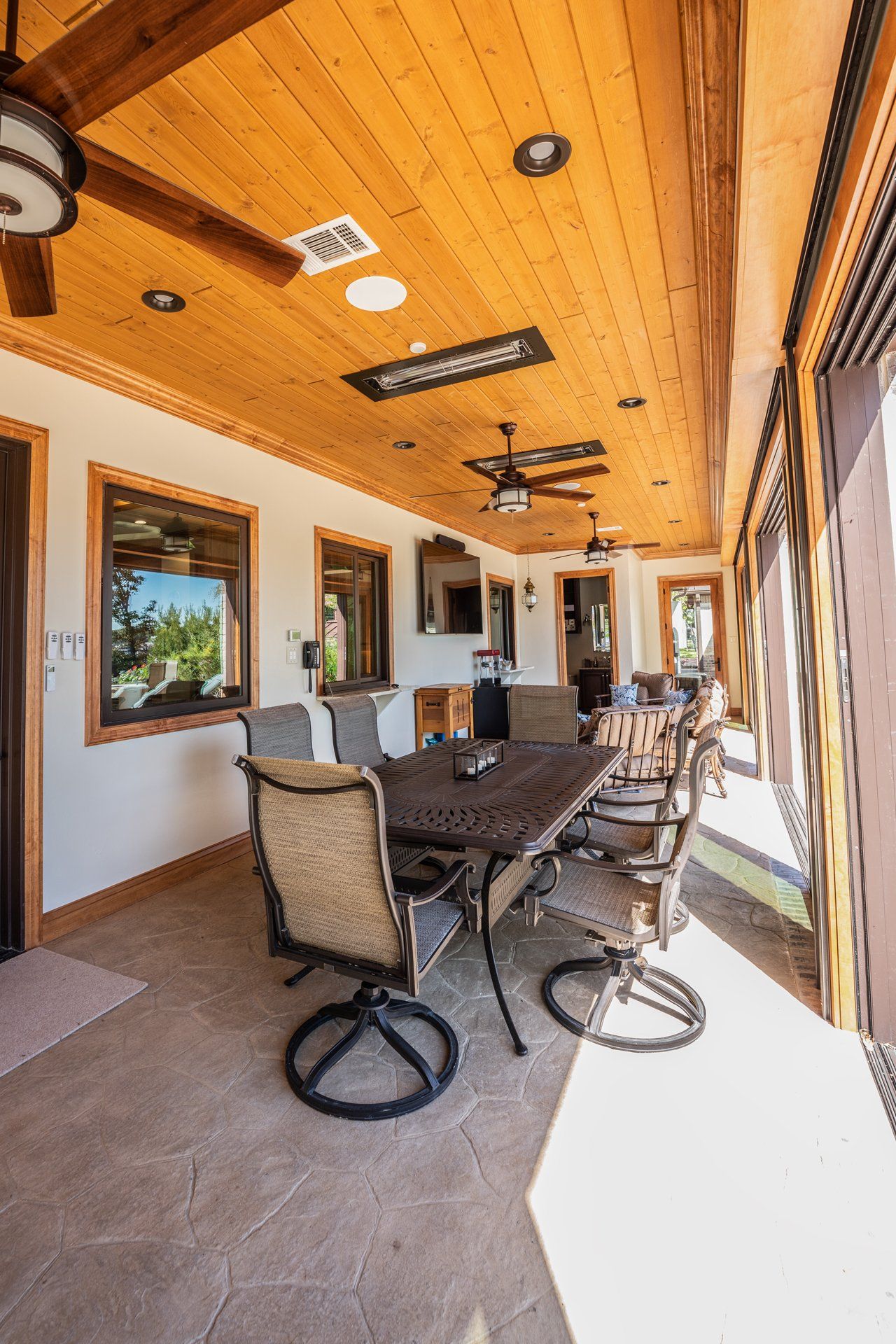 A dining room with a table and chairs and a ceiling fan.