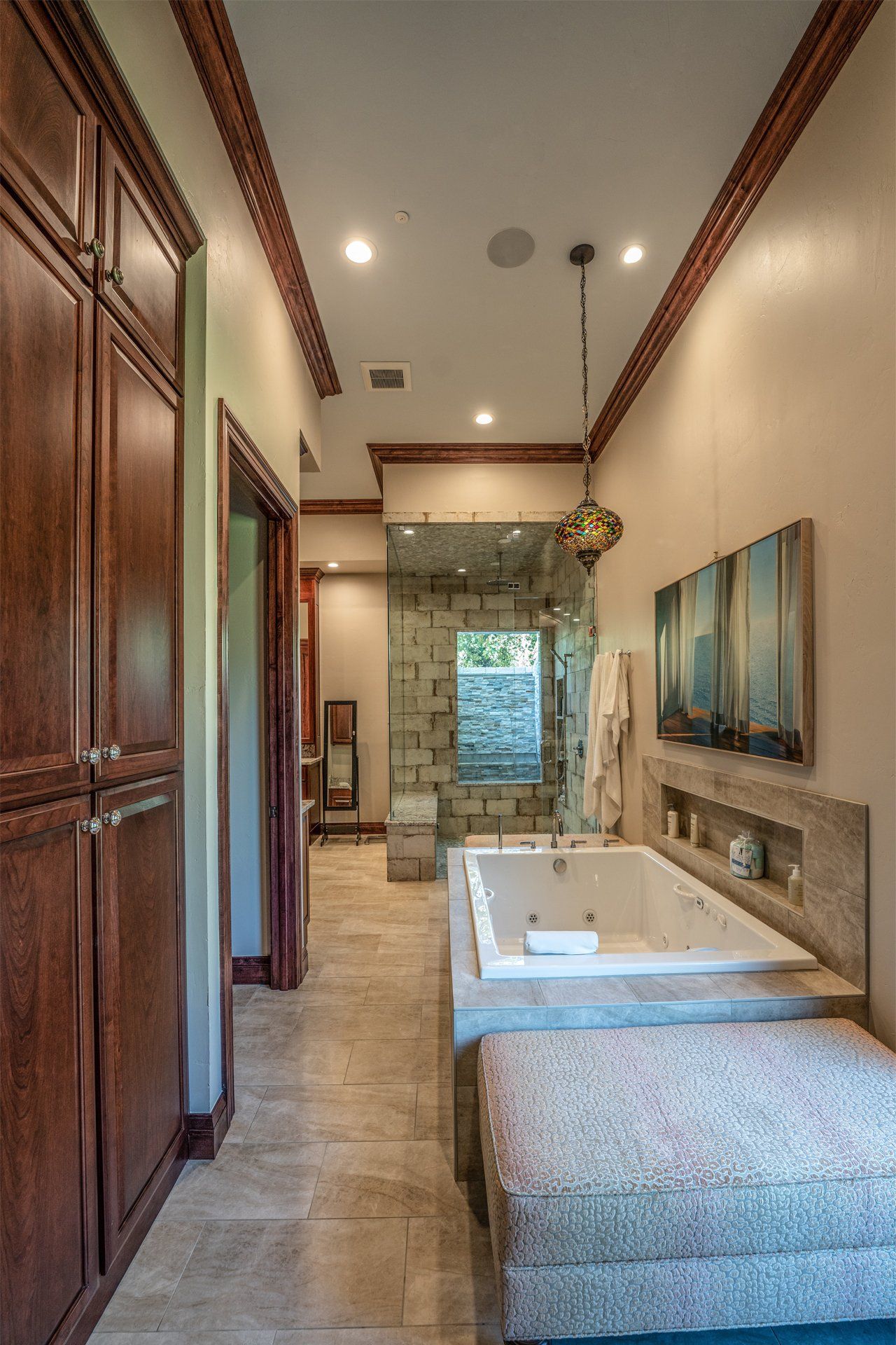 A bathroom with a jacuzzi tub and a walk in shower.
