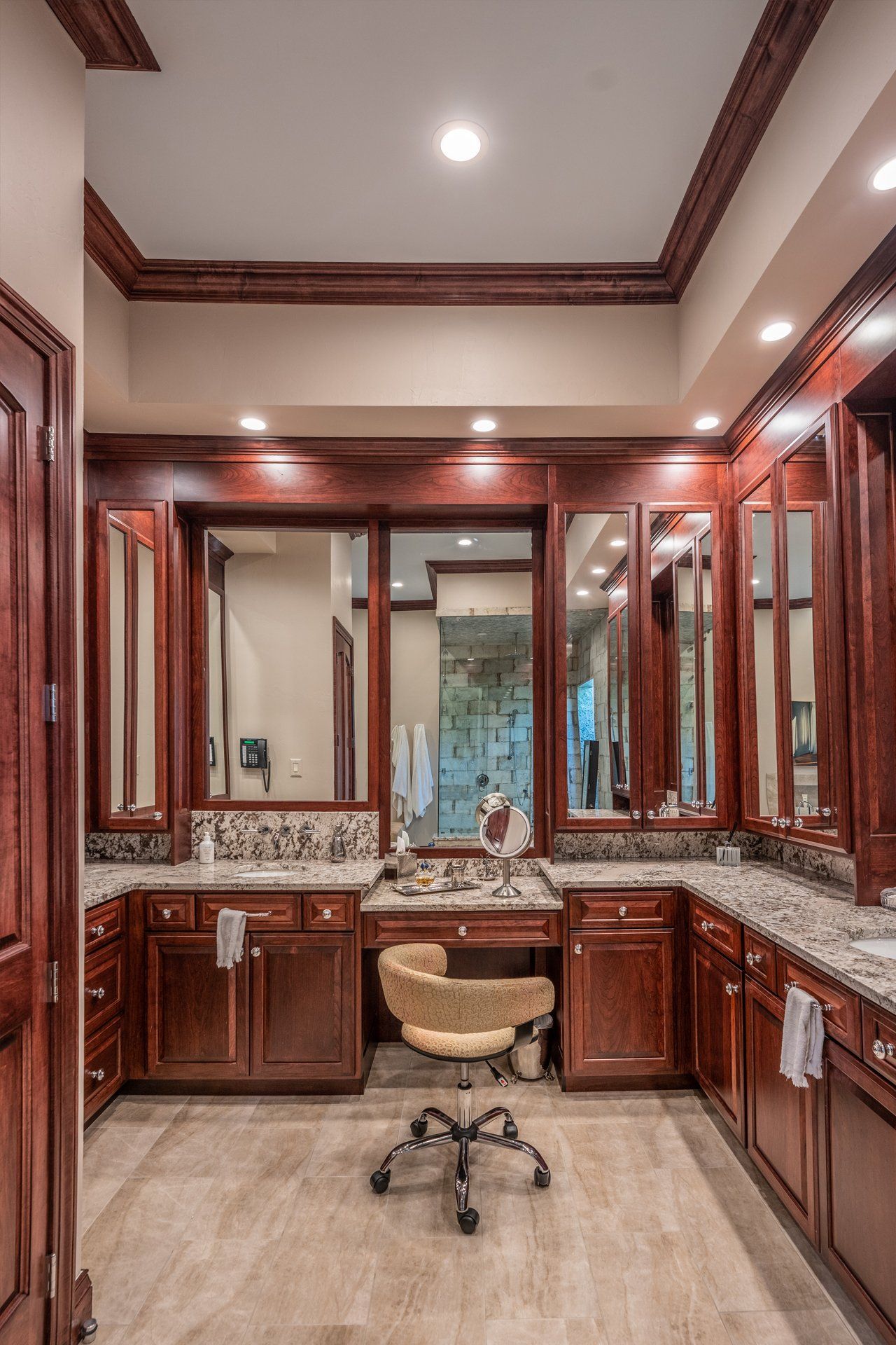 There is a chair in the middle of the bathroom.