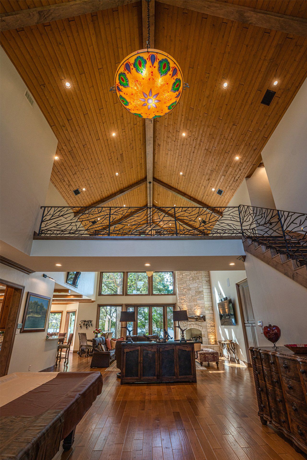 A large living room with a chandelier hanging from the ceiling.