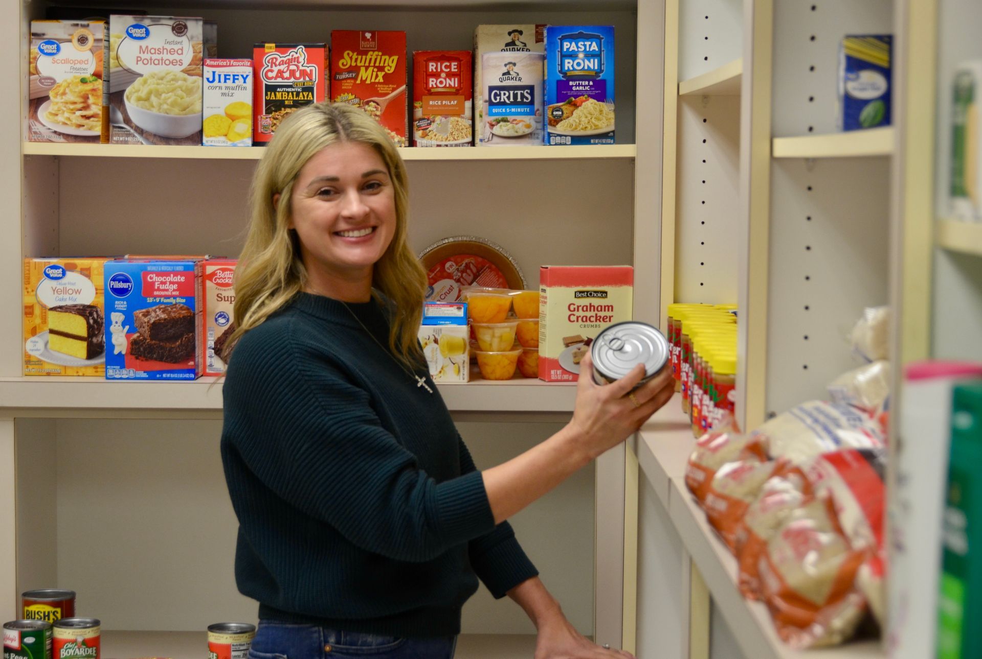 Family of Chasity Verret Martinez poses outdoors in front of tree and grassy field. They wear semi-formal attire, smiling.