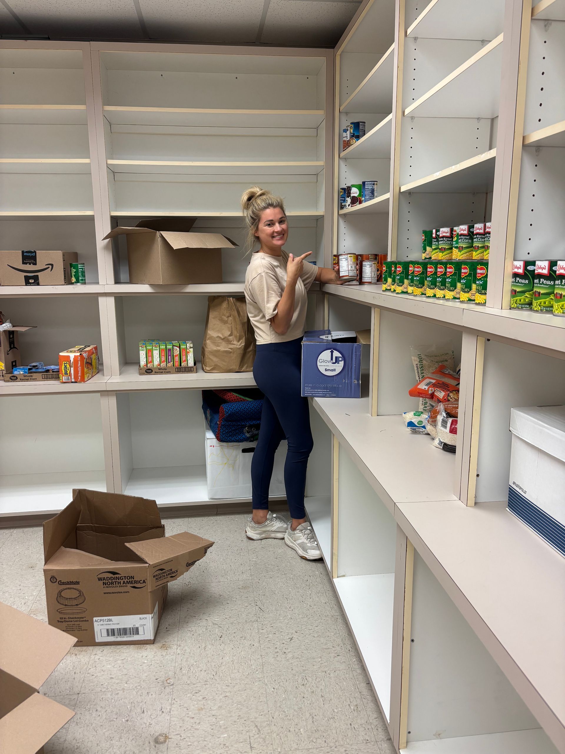 Family of Chasity Verret Martinez poses outdoors in front of tree and grassy field. They wear semi-formal attire, smiling.