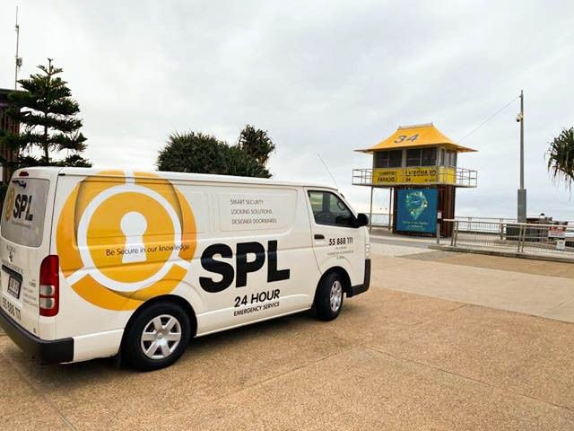 SPL security solutions van in front of lifeguard tower on gold coast beach