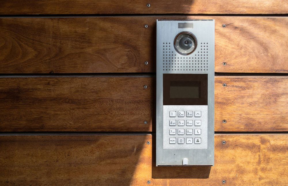 A Smart Security Doorbell Is Mounted On A Wooden Wall — SPL Security Solutions In Coolangatta, QLD