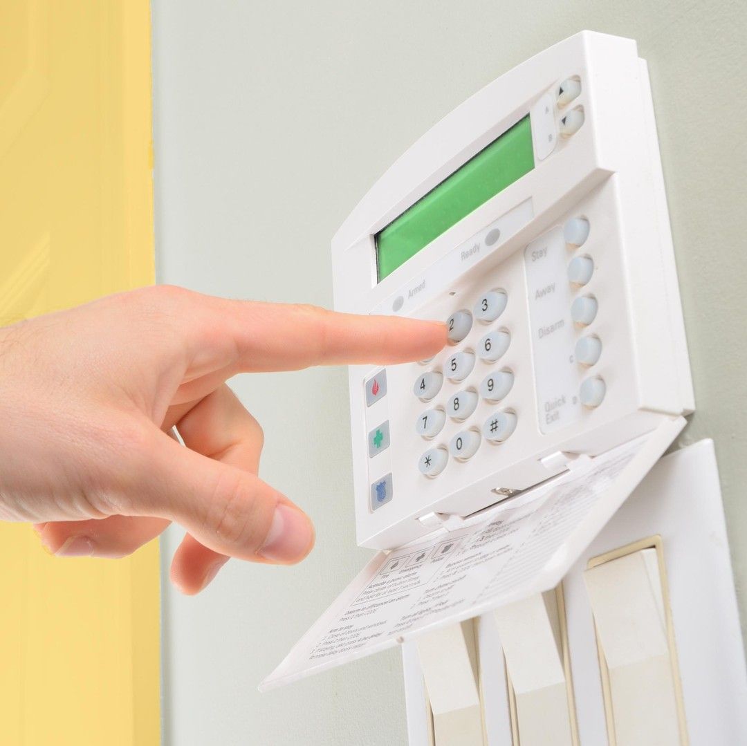 A Person is Pressing a Button on a Security System — SPL Security Solutions In Surfers Paradise, QLD