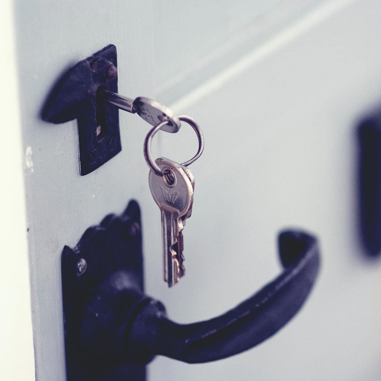 A Pair of Keys Hanging From a Door Handle — SPL Security Solutions In Gold Coast, QLD