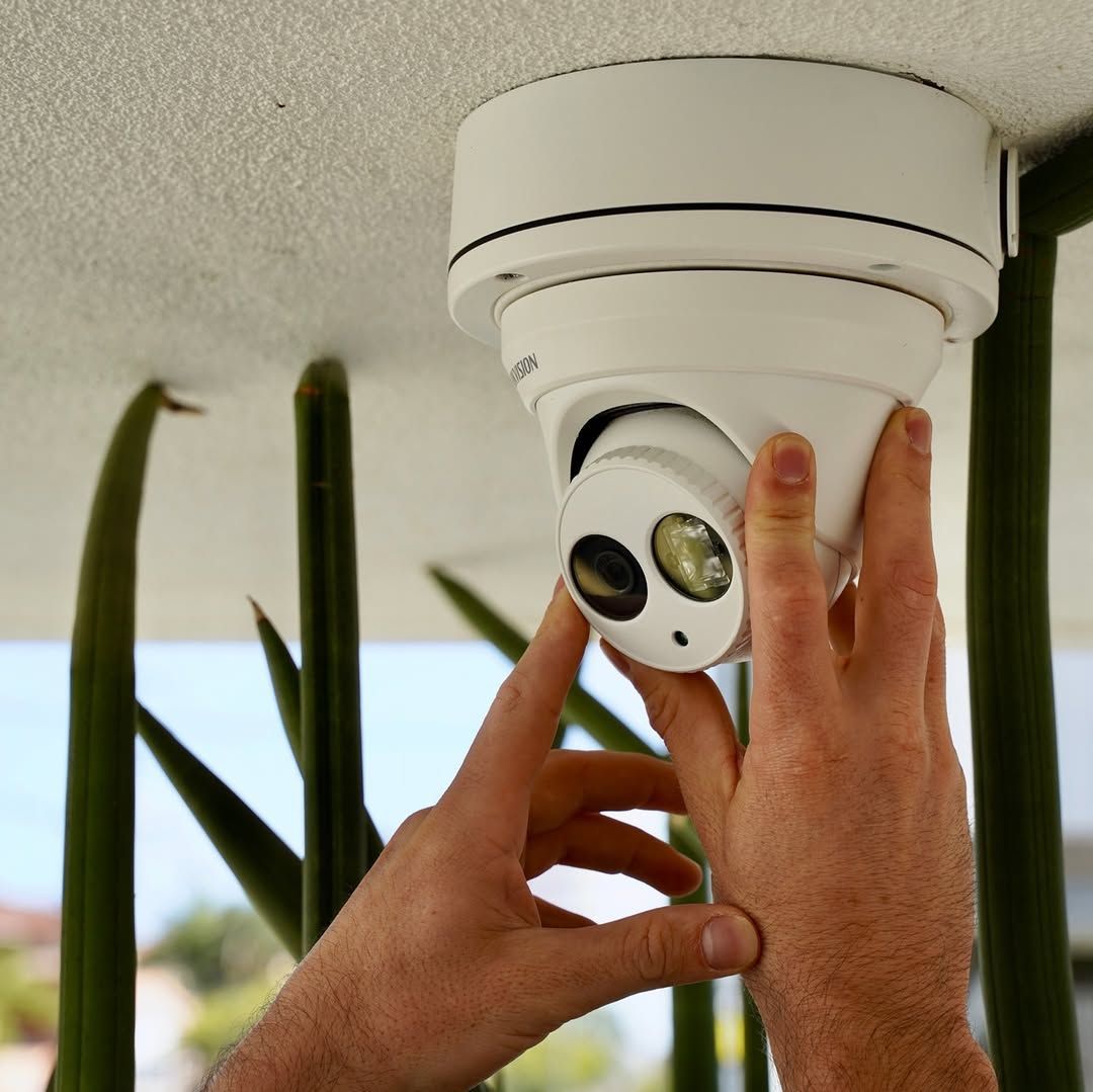 A Person is Installing a Security Camera on the Ceiling — SPL Security Solutions In Oxenford, QLD
