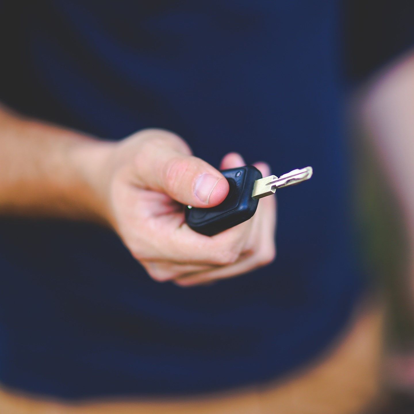 A Man is Holding A Car Key — SPL Security Solutions In Bundall, QLD
