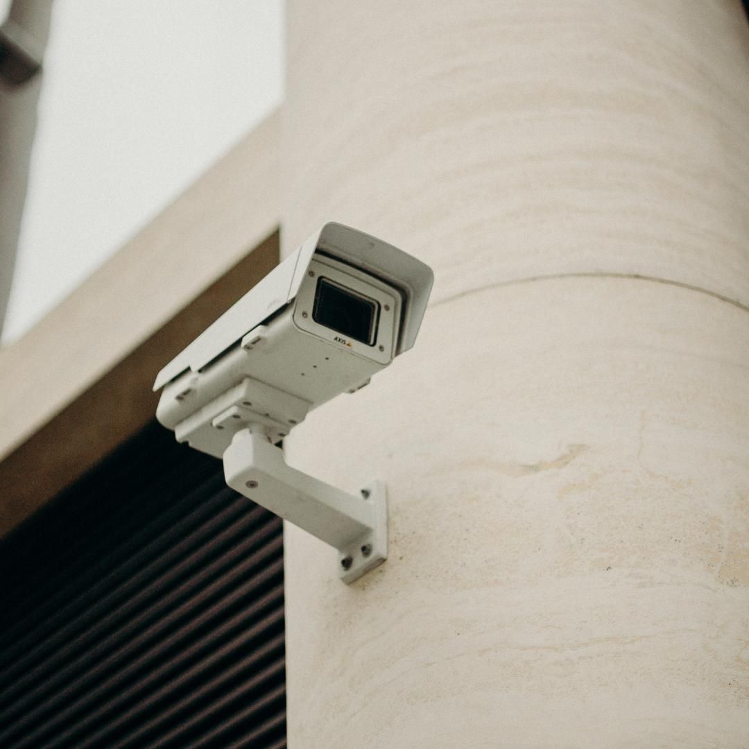 A Security Camera is Mounted on the Side of a Building — SPL Security Solutions In Tweed Heads, NSW