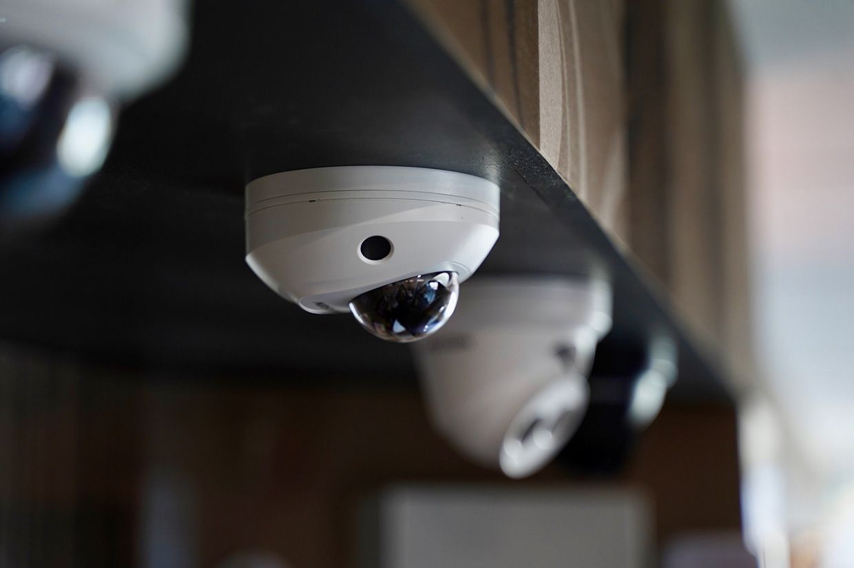A Row of Security Cameras Hanging From the Ceiling of a Building — SPL Security Solutions In Kingscliff, NSW