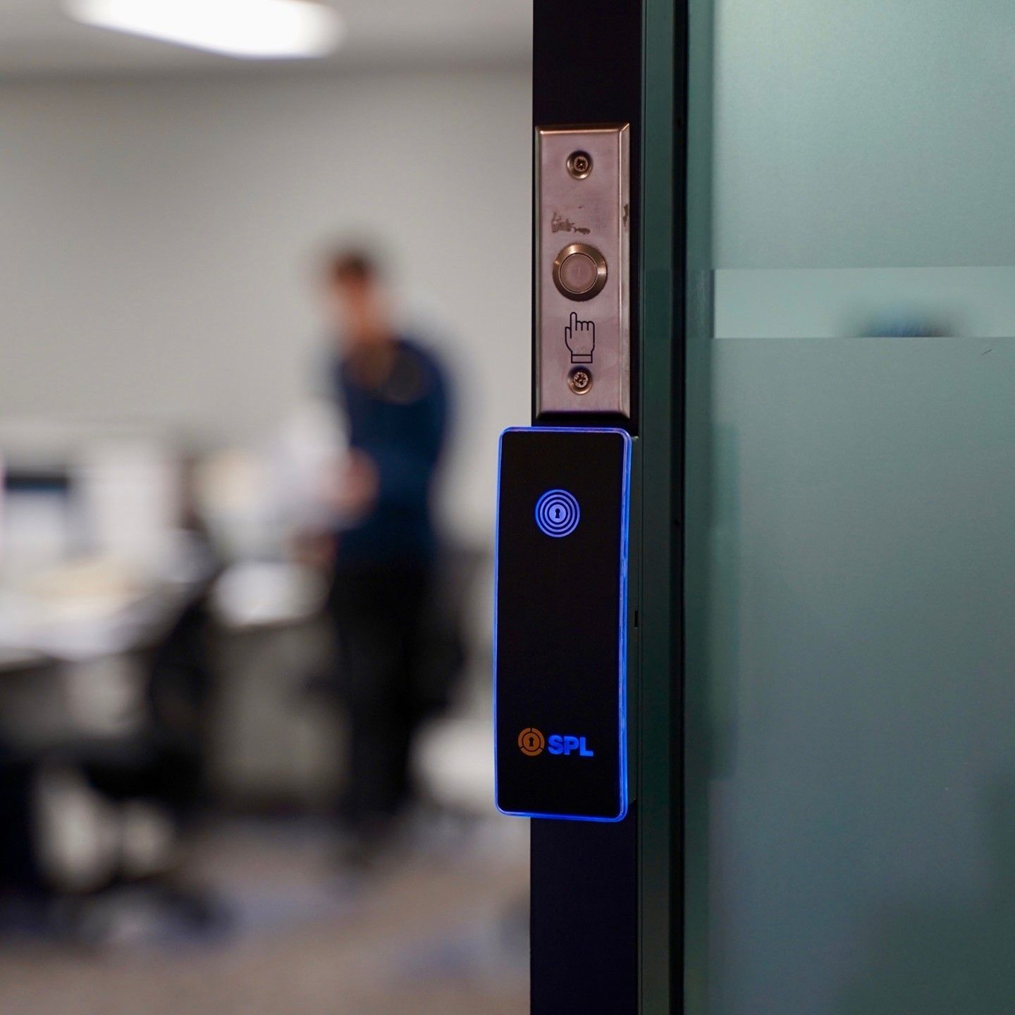 A Blurry Picture of a Man Standing Behind a Glass Door — SPL Security Solutions In Oxenford, QLD
