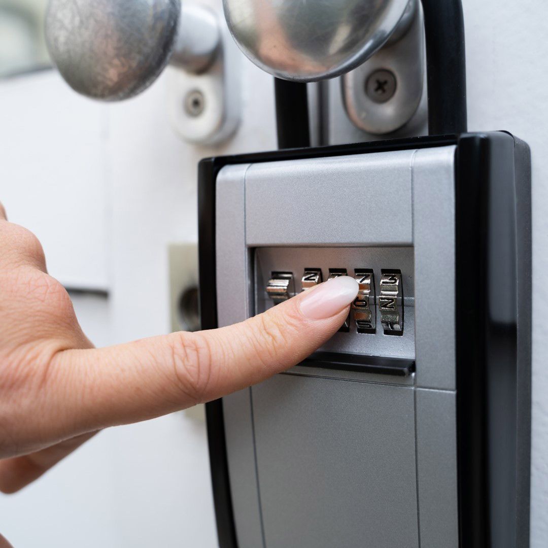 A Person's Finger is Pressing a Button on a Key Safe — SPL Security Solutions in Bundall, QLD