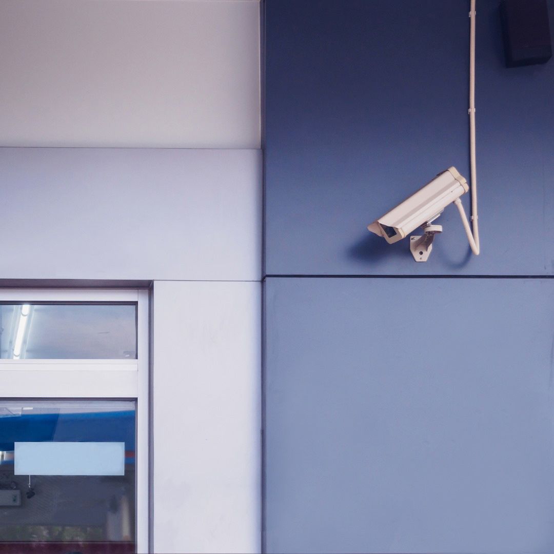 A Security Camera is Mounted on the Side of a Building — SPL Security Solutions In Tweed Heads, NSW