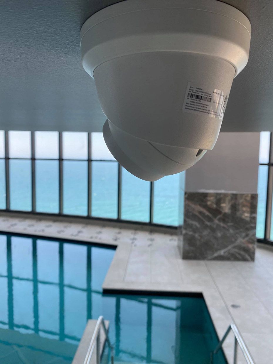A Ceiling Mounted Camera Over a Swimming Pool — SPL Security Solutions In Surfers Paradise, QLD