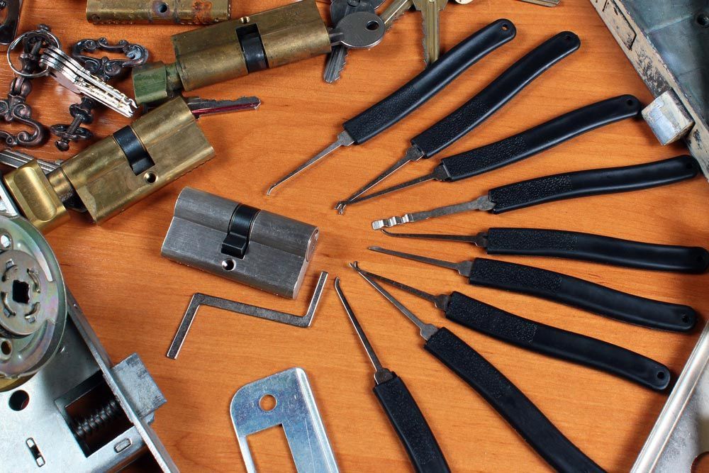 A Bunch Of Keys And Tools On A Wooden Table — SPL Security Solutions In Southport, QLD