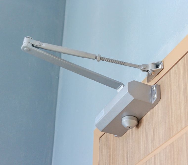 Person Is Holding A Cell Phone In Front Of A Door — SPL Security Solutions in Bundall, QLD