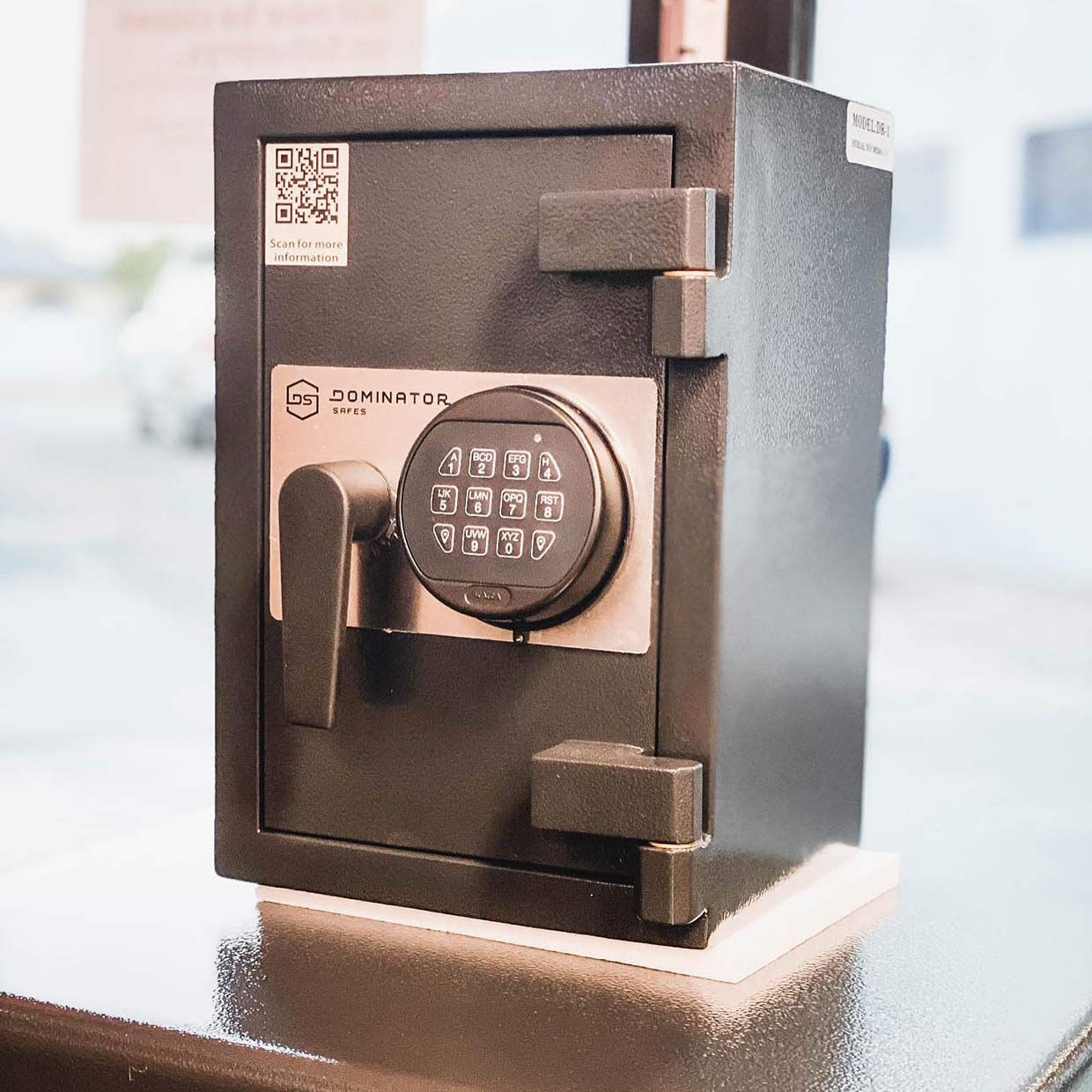 A Safe With a Digital Lock is Sitting on a Table — SPL Security Solutions In Surfers Paradise, QLD
