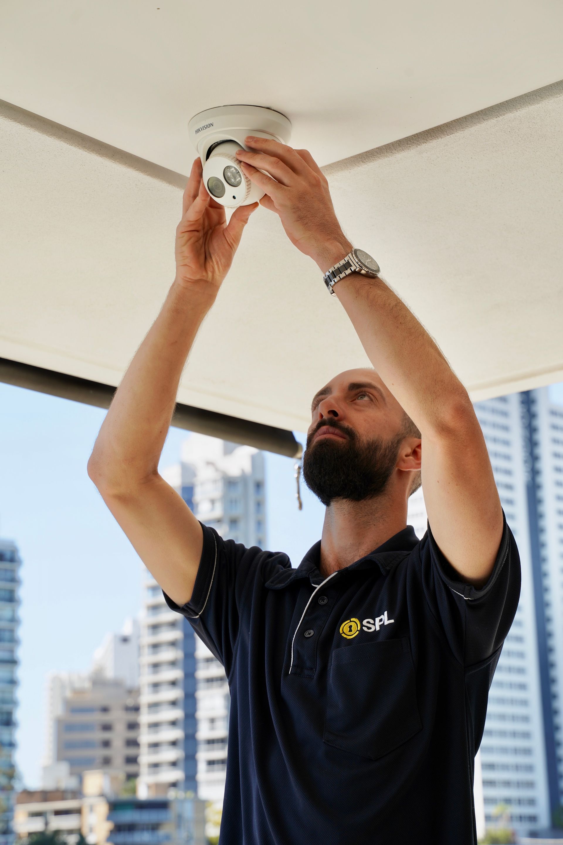 Person Is Installing A Security Camera — SPL Security Solutions in Bundall, QLD
