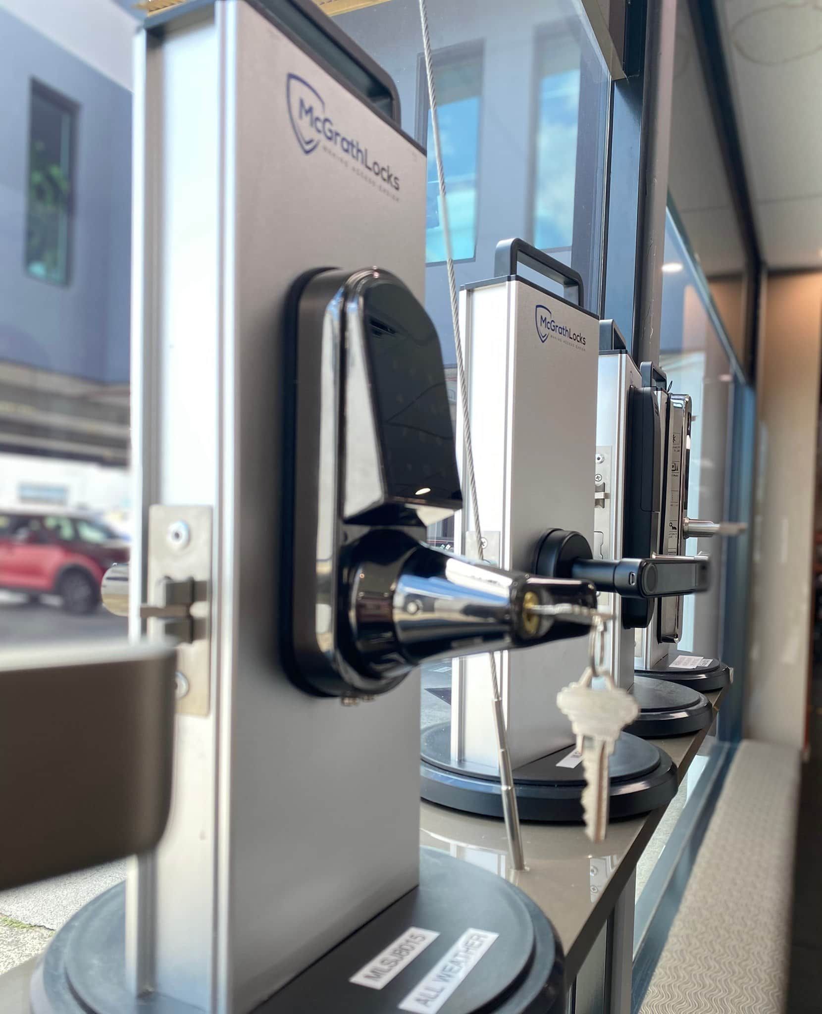 Display of Several Silver Door Locks With Black Accents and Keys.