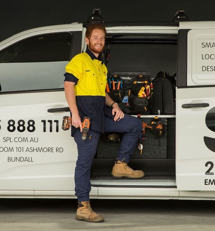 A Man Is Standing Next To A White Van — SPL Security Solutions in Bundall, QLD