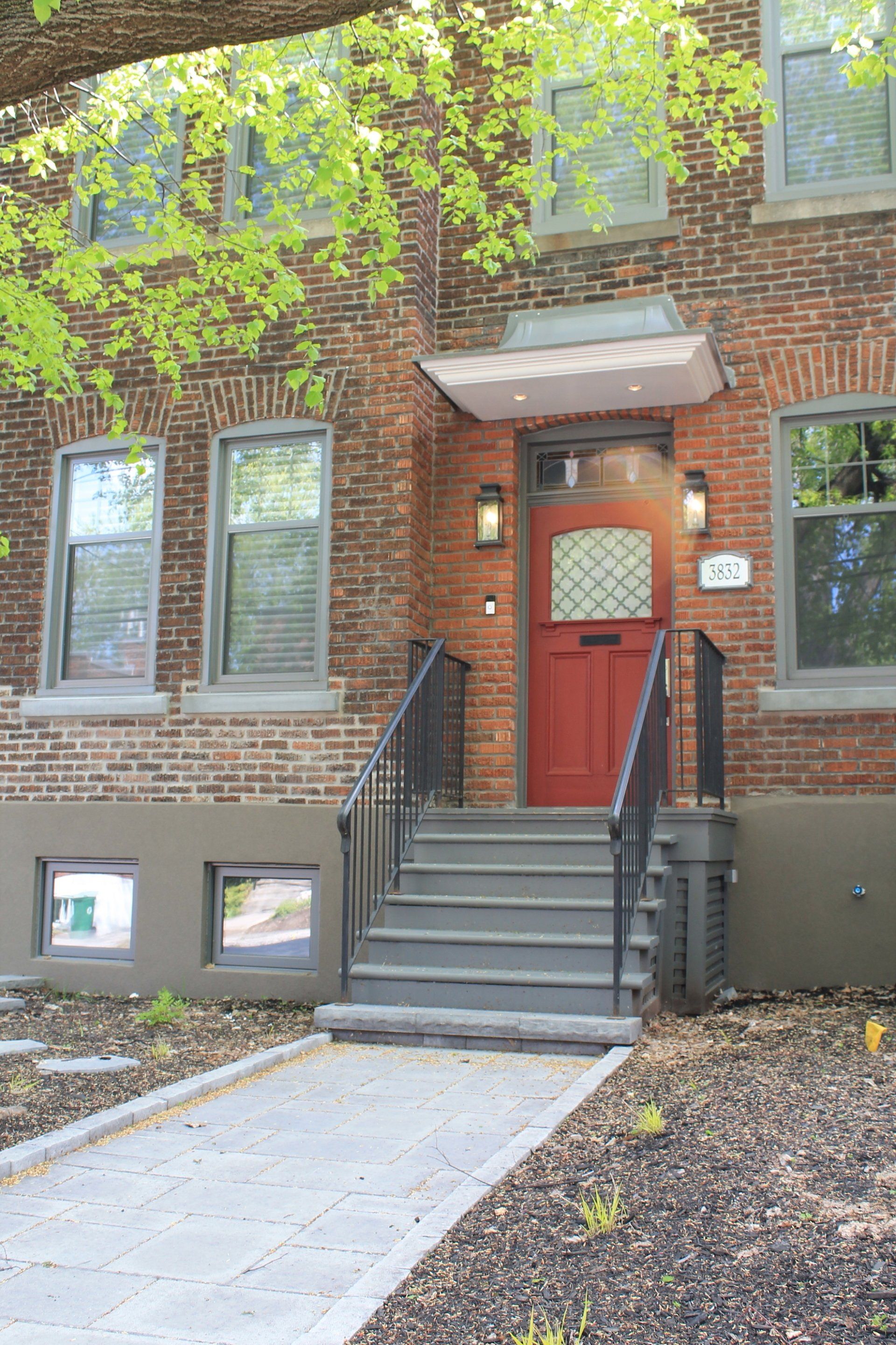 front view of apartment with red door and walkway