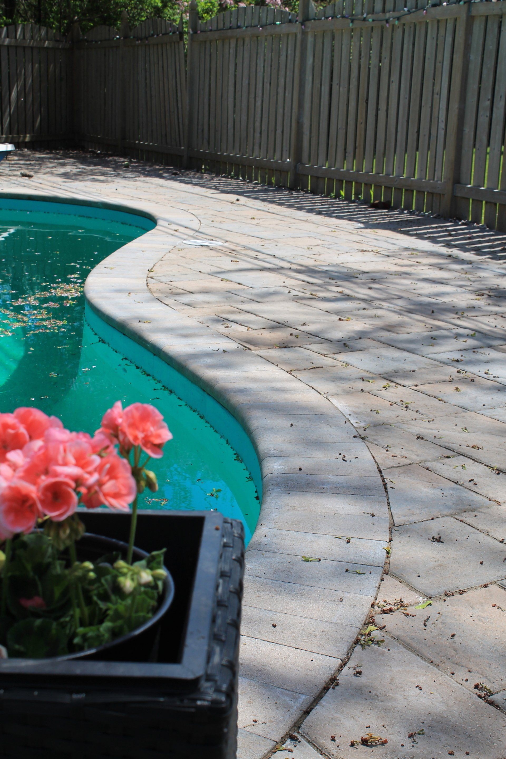 pool surrounded by grey and beige unistone