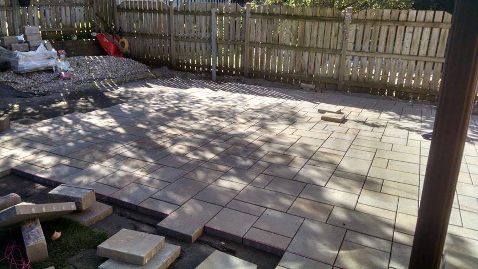 beige unistone being installed with fence