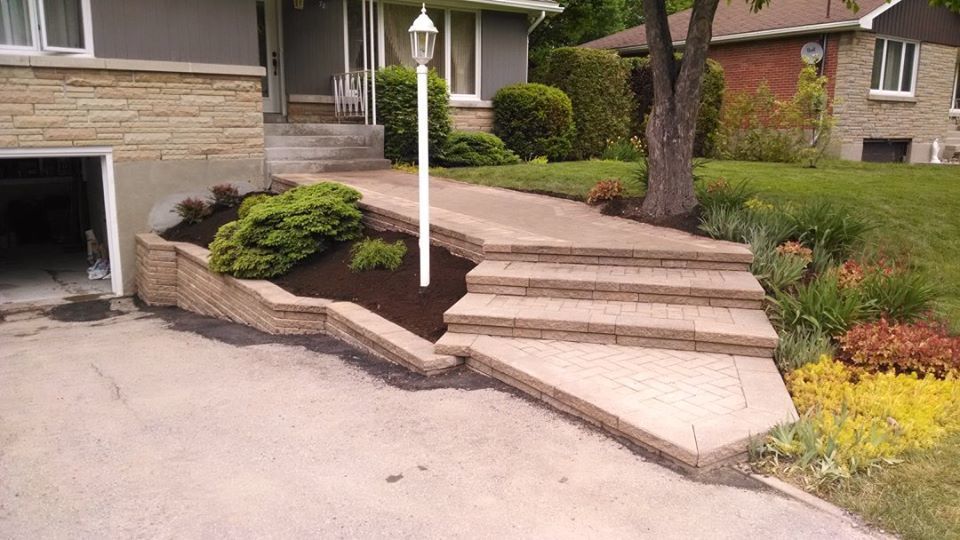 light beige driveway with unistone stairs and flower bed
