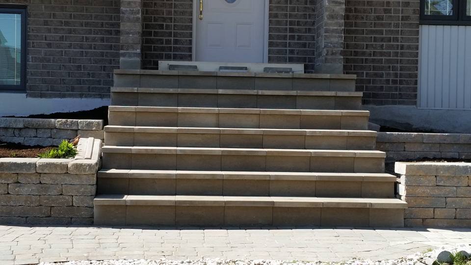 unistone stairs leadin to house with white door