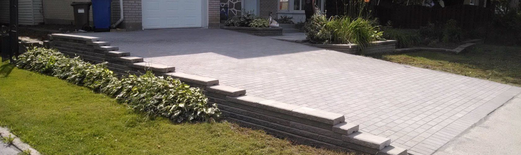 beige unistone driveway and green grass