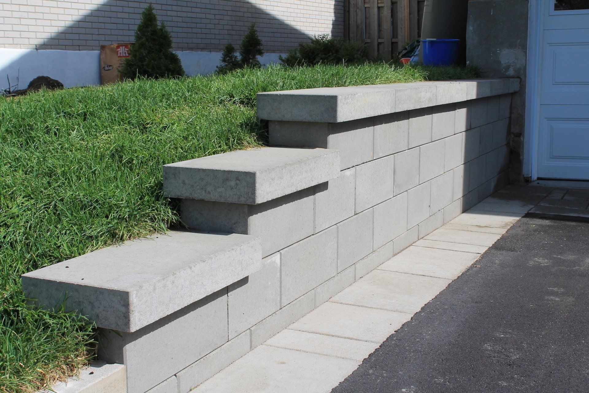 grey brick wall and parking lot