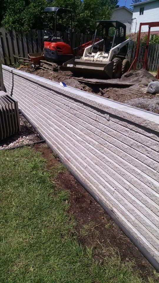 white brick wall with green grass next to it