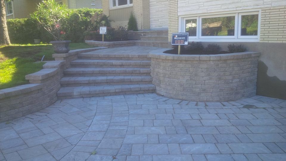 front of home with unistone driveway and staricase