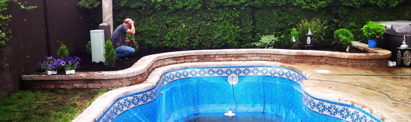 worker filling up blue inground pool