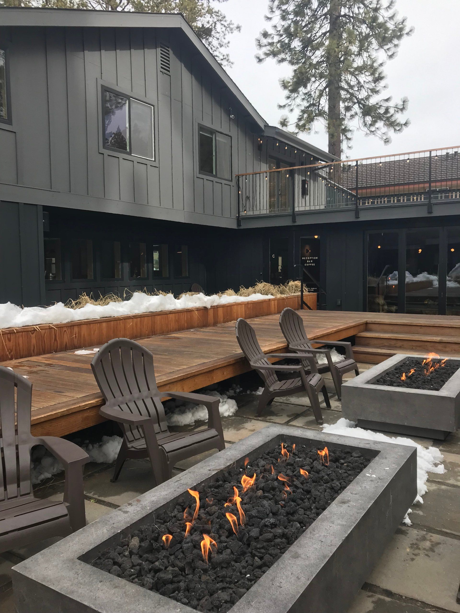 outdoor firepit surrounded by black patio chairs