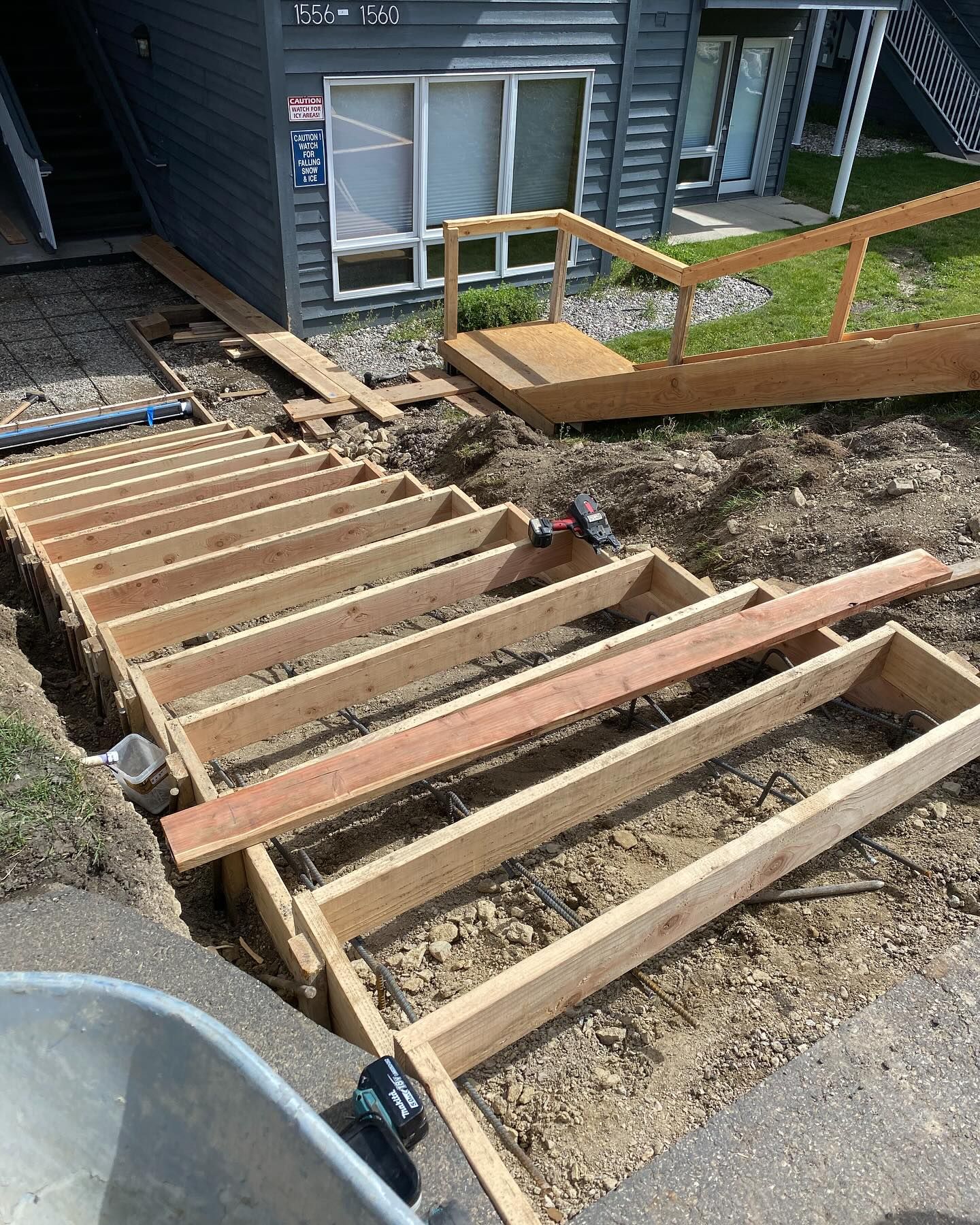 A wooden deck is being built in front of a building.