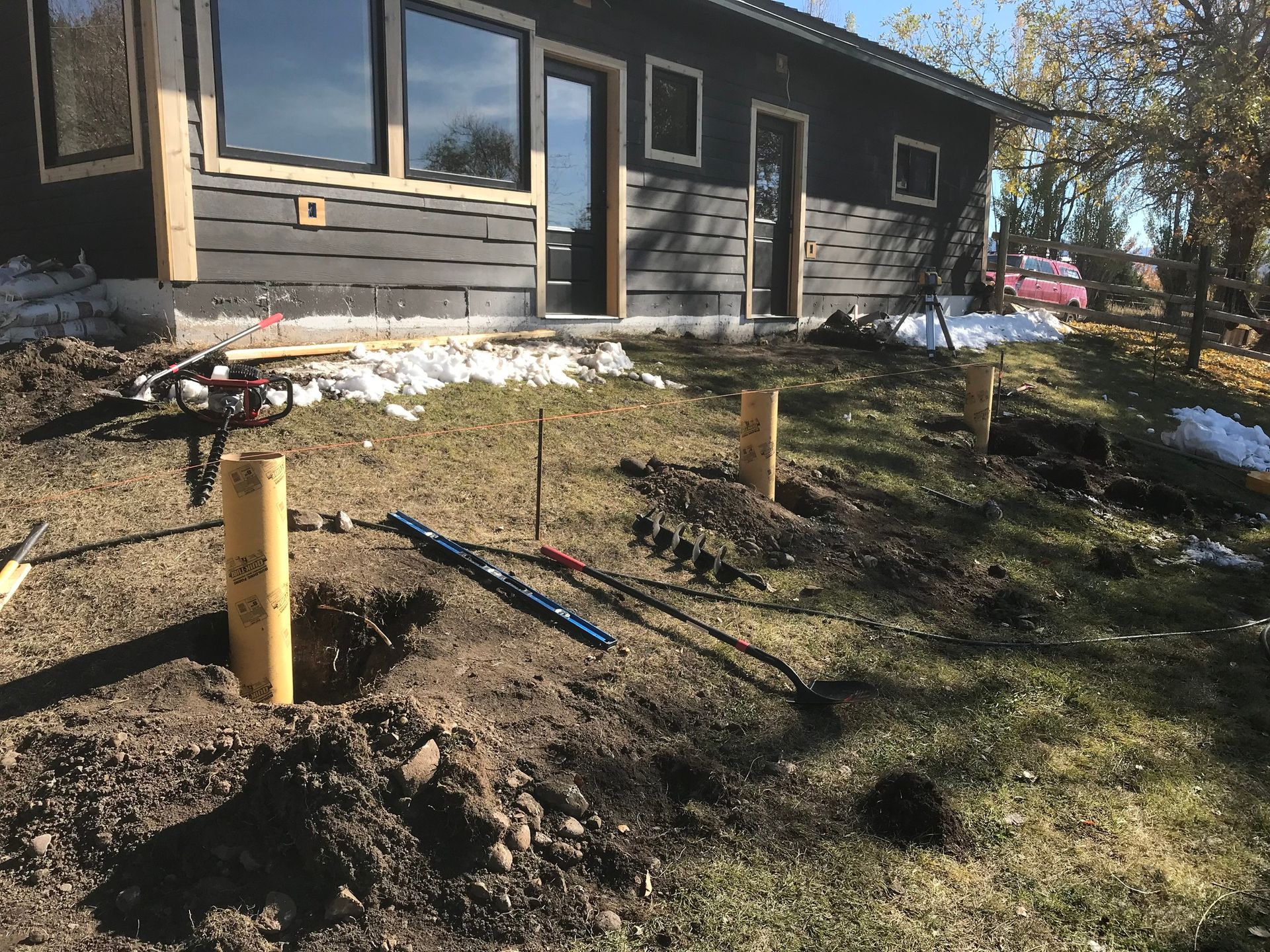 A house is being built on a hill with a lot of dirt in front of it.