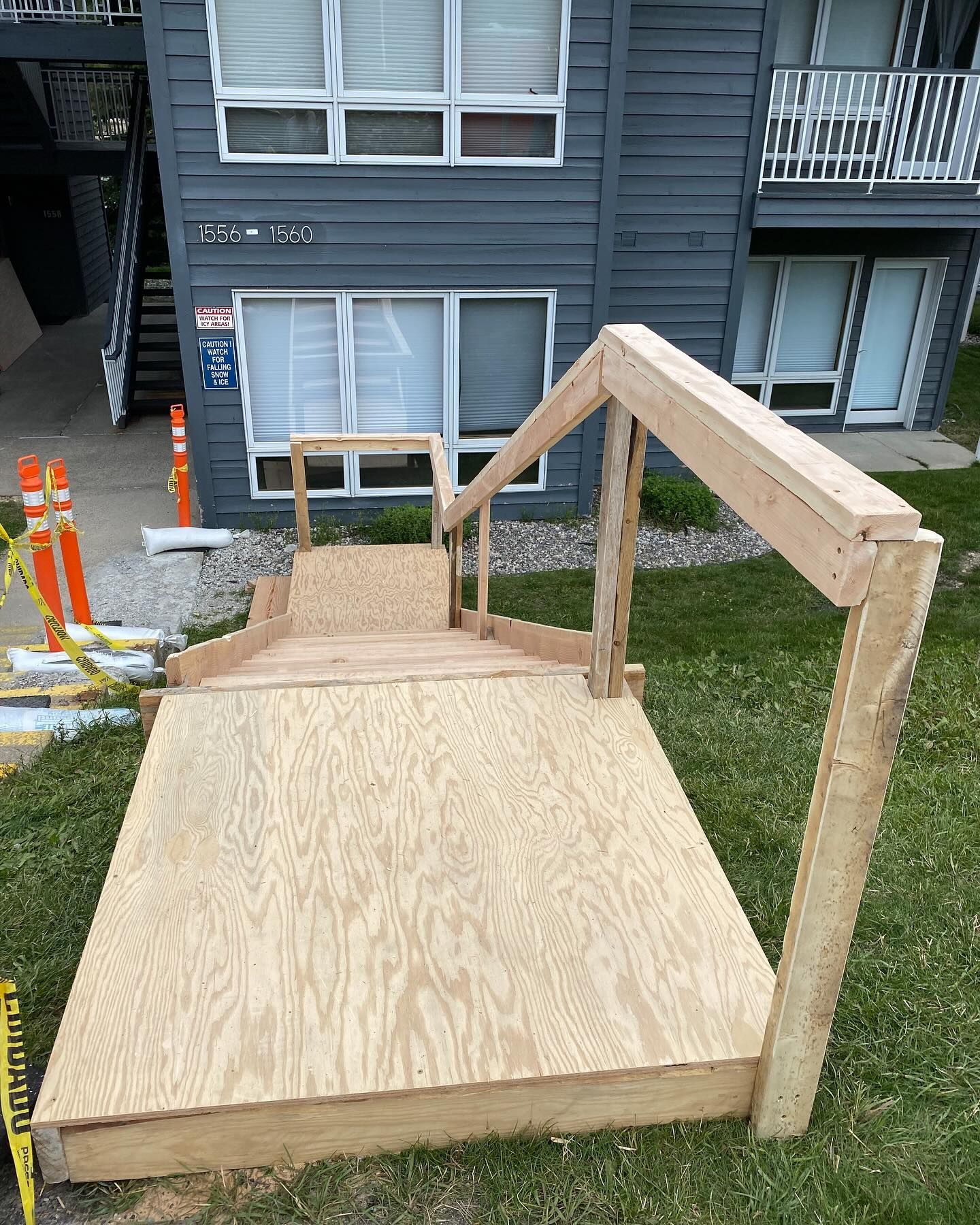 A wooden staircase is being built in front of a building.