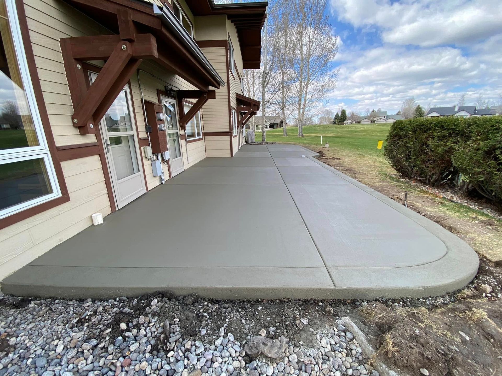 A concrete walkway is being built in front of a house.