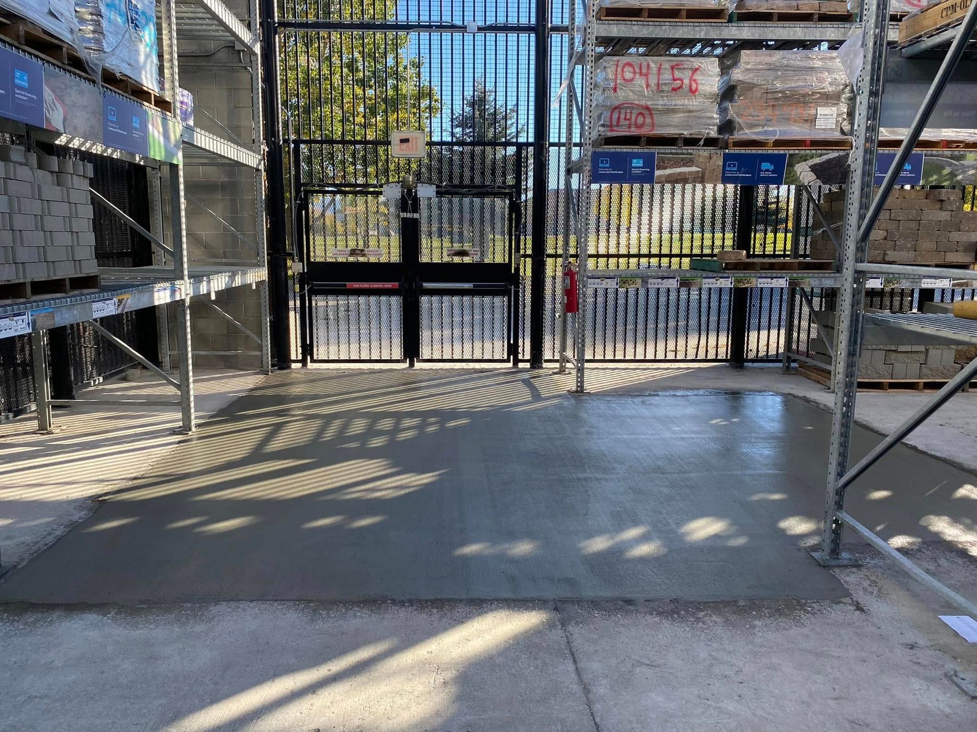 A warehouse with a gate and a concrete floor.