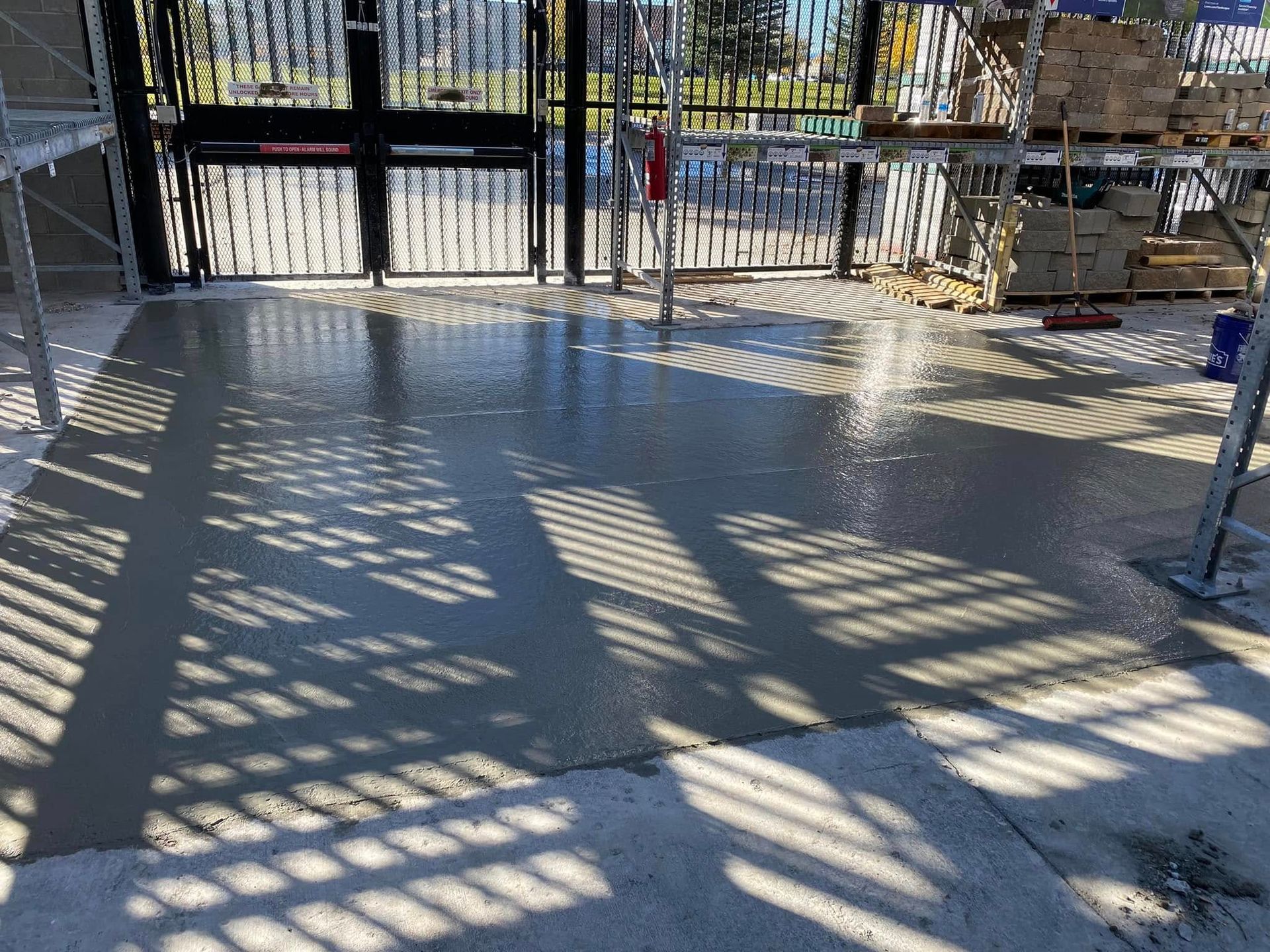 A concrete floor is being poured in a building under construction.