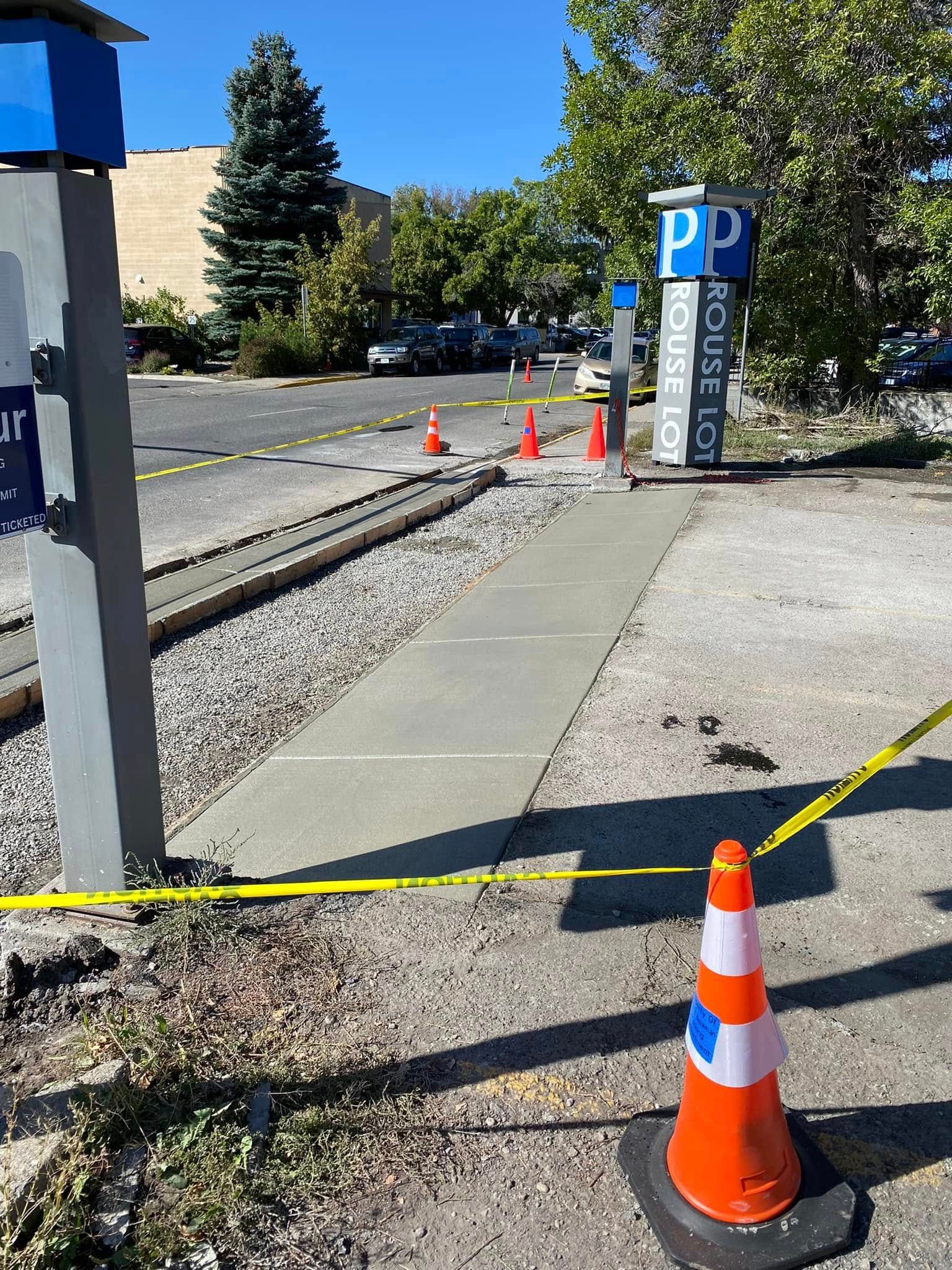 A concrete walkway is being built next to a train track.