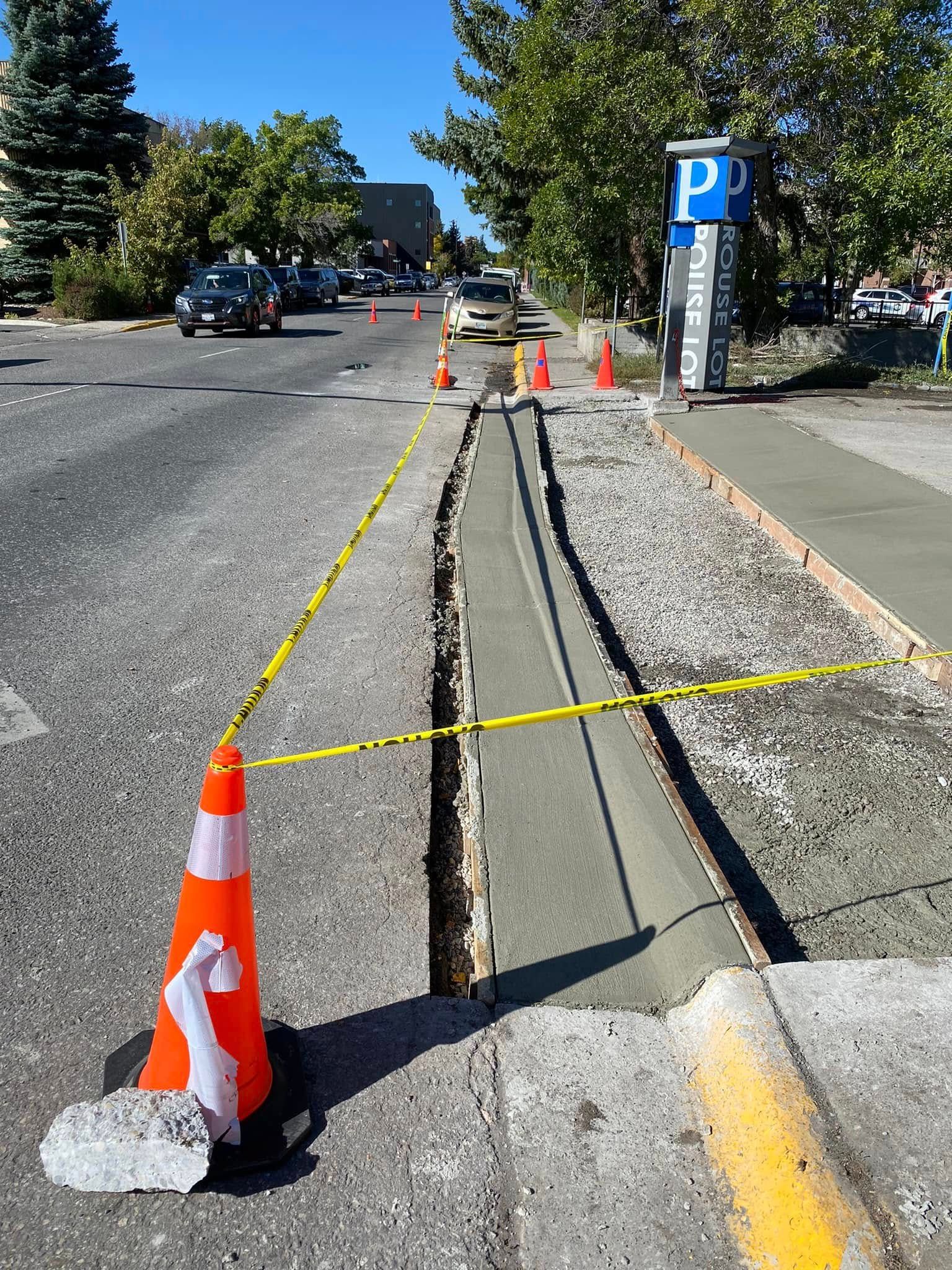 A concrete curb is being built on the side of the road