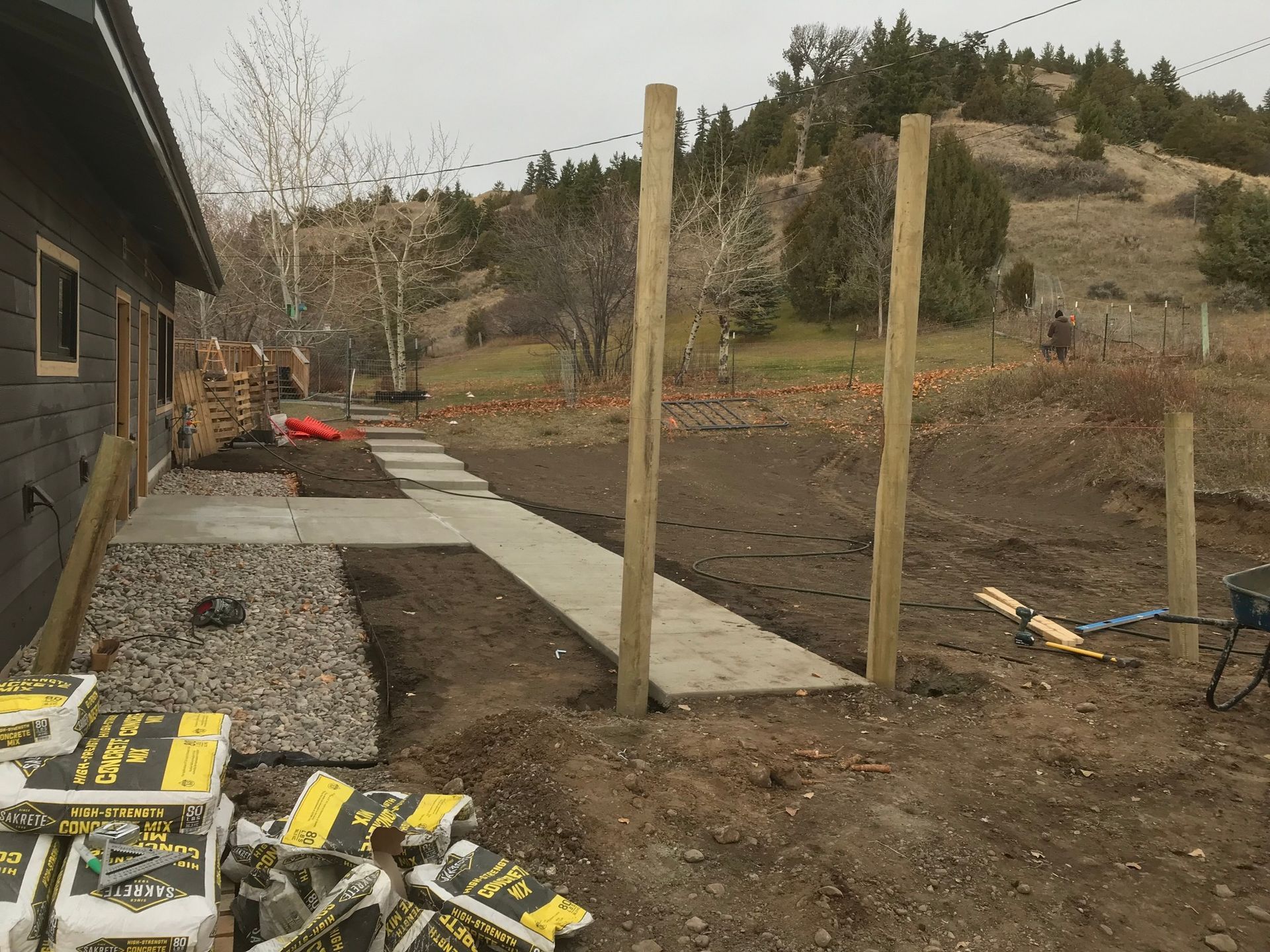 A fence is being built in front of a house