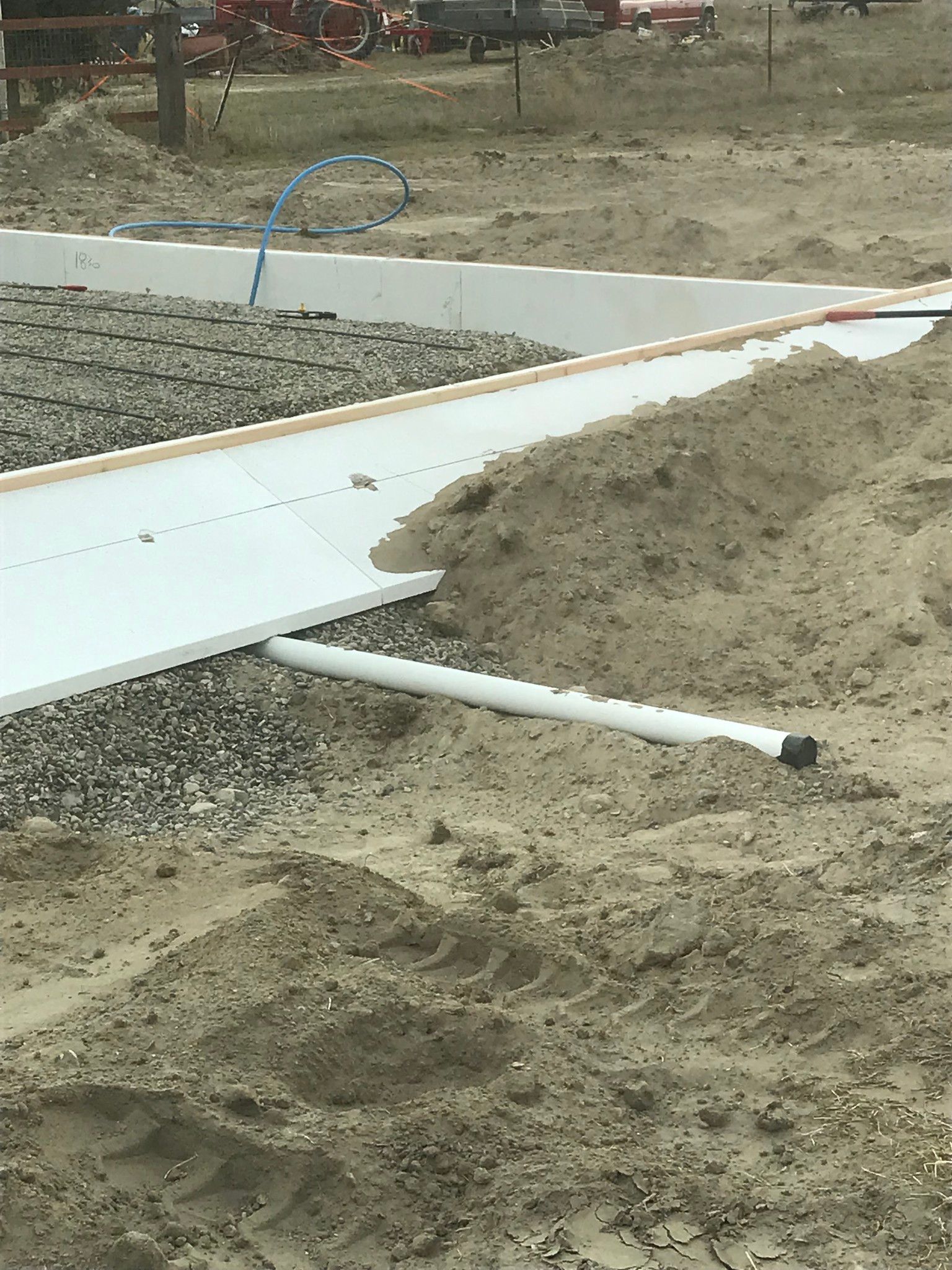 A pipe is laying in the dirt on a construction site.