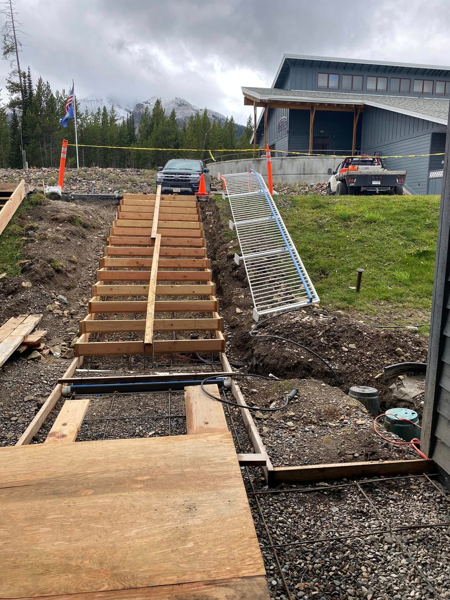 A wooden staircase is being built in front of a house.