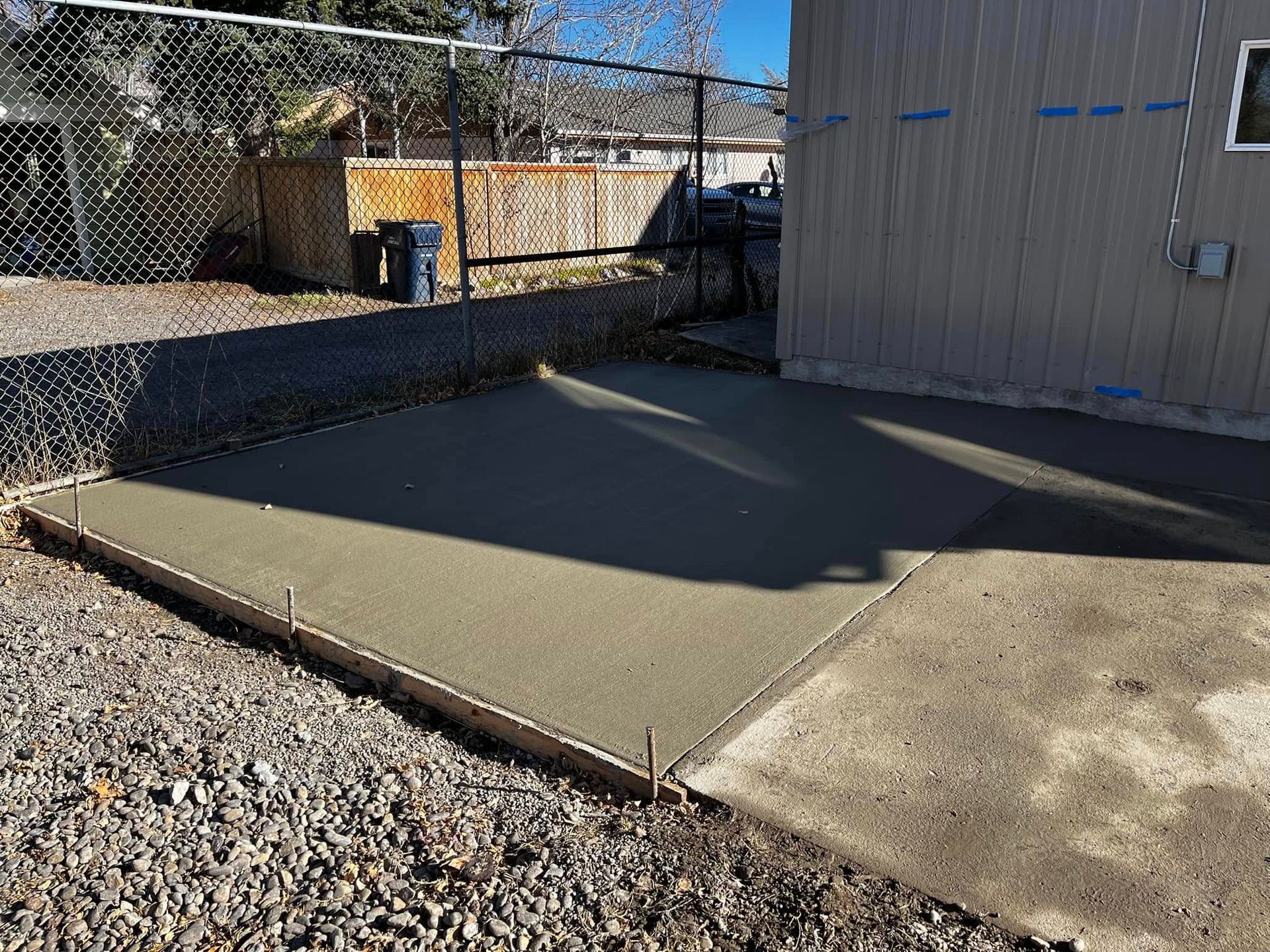 A concrete driveway is being built in front of a building.