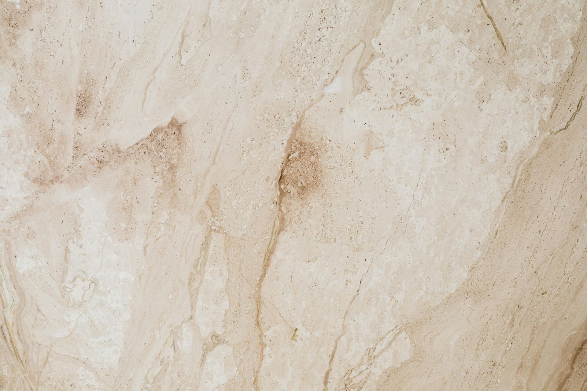 Beige and tan marbled stone surface.
