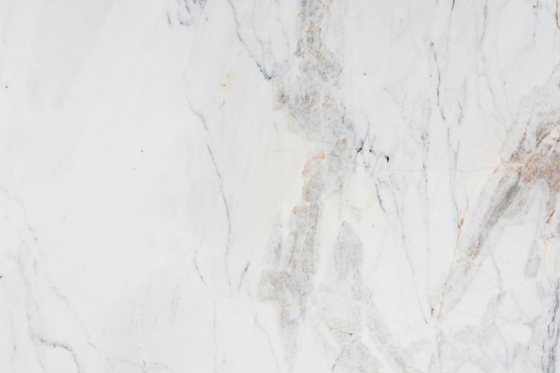 White marble surface with subtle gray and beige veining.